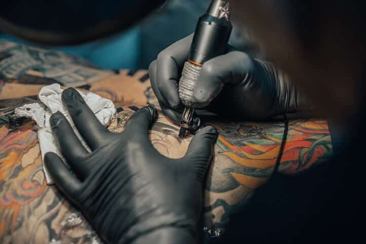 why tattooists wear black gloves